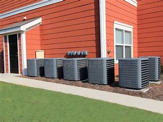6813ee7ae216d_ac units along wall Air conditioning units outside brick building.
